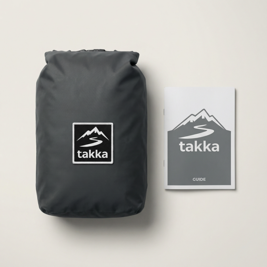 Bolsa estanca takka + guía del kit Bolsa estanca negra con logotipo takka junto a una guía impresa del kit sobre fondo claro.